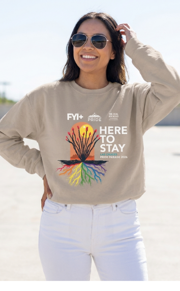 Person wearing the tan Here to Stay crewneck